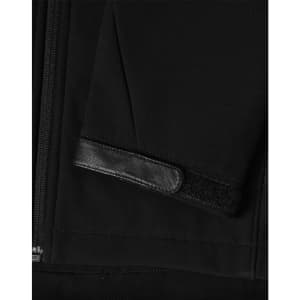 A black softshell jacket featuring a zippered front and a textured patch on the sleeve. It has a logo.