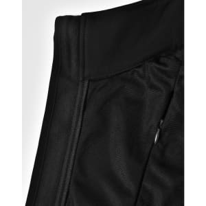 A black softshell vest featuring a zip pocket and a sleek design, with an attached logo.