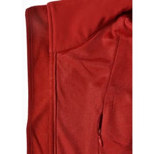 A red softshell vest featuring a smooth exterior and a textured interior, with a zippered pocket and a logo.