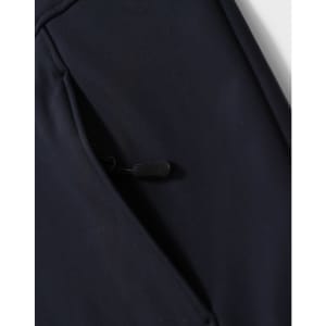 A navy softshell full zip hoodie featuring a zippered pocket on the side and a logo.