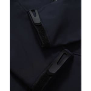 A dark navy softshell hoodie featuring zippered pockets and Velcro closures. It has a sleek and modern design.