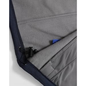 A close-up of a navy softshell hoodie featuring a grey fleece lining and a drawstring at the hem.