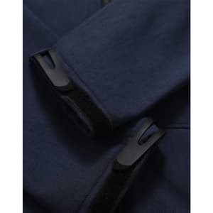 A close-up of a navy softshell hoodie featuring cuff details and a logo.