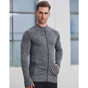 A man wearing a grey seamless jacket with a zip, featuring a fitted design and pockets.
