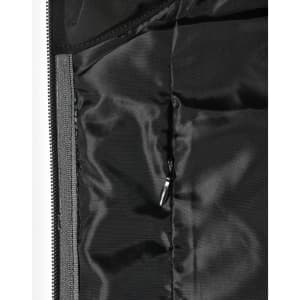 A close-up of a quilted jacket's interior lining in black, featuring a zippered pocket and smooth texture.