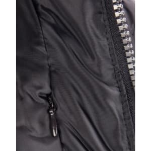 A close-up of a heavy quilted black puffer jacket featuring a zip and a side pocket. It has a logo on the front.