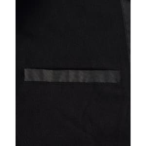 A close-up of a black long line stadium jacket featuring a sleek design and a pocket. The jacket has a branding logo.