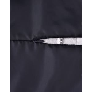 A close-up of a black insulated puffer jacket featuring a zippered pocket and a soft lining.
