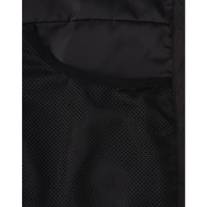 A close-up of the interior of a black insulated puffer jacket, featuring mesh pockets.