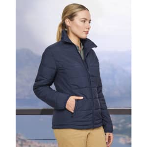 A navy insulated puffer jacket with a 3D cut and side pockets, displayed on a model against a scenic backdrop.