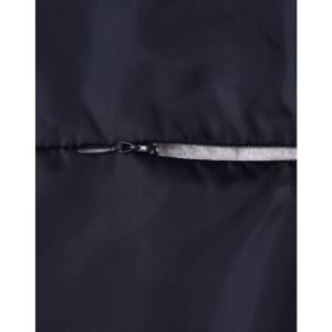 A close-up of a dark puffer jacket featuring a zip closure and a smooth fabric texture. The jacket has a logo.