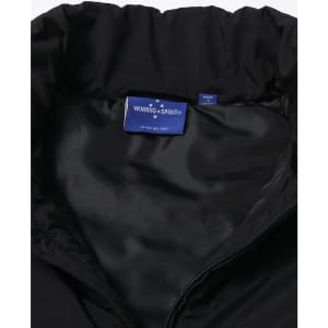 A black insulated puffer vest featuring a smooth inner lining and a logo tag inside the collar.