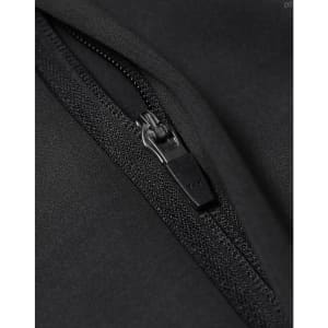 A close-up of a black softshell jacket featuring a zipper detail and a textured fabric finish.