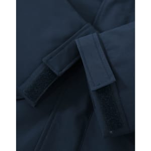 A close-up of a navy unisex quilted waterproof jacket featuring adjustable velcro cuffs and a smooth fabric finish.