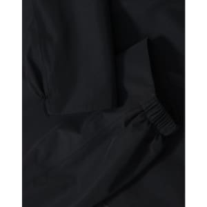 A waterproof jacket in black featuring elasticated cuffs and a durable fabric. The jacket has a logo present.