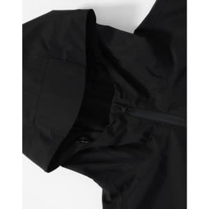A black unisex waterproof jacket featuring a hood and zip closure, with a logo on the fabric.