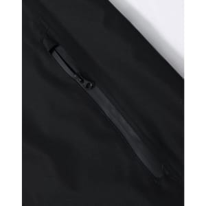 A black waterproof jacket featuring a zippered pocket and a smooth fabric texture. It has a logo on the jacket.