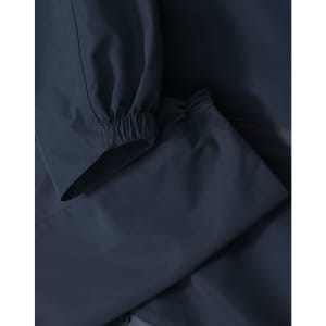 A waterproof jacket in navy blue with elastic cuffs and a sleek design, featuring a logo.