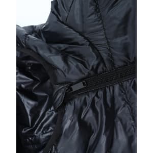 A close-up of a lightweight hooded puffer jacket in black, showcasing its zipper and inner lining.