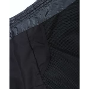 A lightweight hooded puffer jacket in black, featuring a mesh interior and a sleek design. It has a logo.
