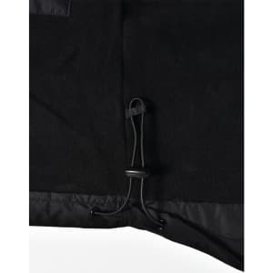 Detail of a black fleece jacket featuring a drawstring adjustment at the hem. The jacket has a logo.