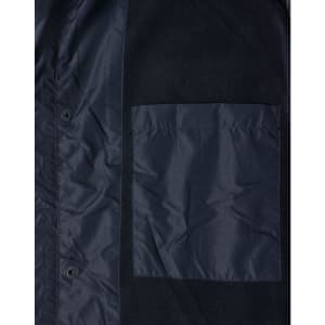 A dark navy unisex jacket featuring a large chest pocket and snap button closures. Includes a logo on the fabric.