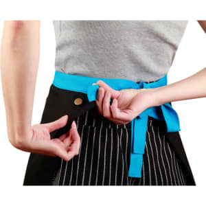 A black canvas short waist apron with a bright blue tie, featuring a branded logo on the side.