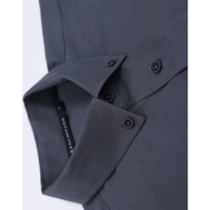 A dark grey cotton blend long-sleeve shirt with a folded collar and button details. It features a logo.