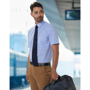 A short-sleeved men's gingham check shirt in blue and white, complemented by a navy tie, worn with khaki trousers.