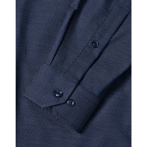 A men's long sleeve button-up shirt in navy with a pin dot pattern and cuff details. Features a logo.