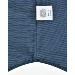 A button-up shirt featuring a pin dot pattern in navy blue, with a care label attached.