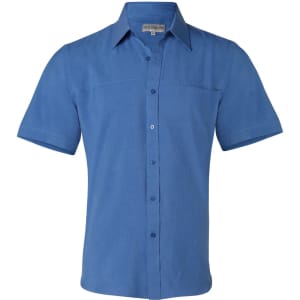A men's short sleeve shirt in a shade of blue, featuring a button-down front and a patch pocket. It has a logo.