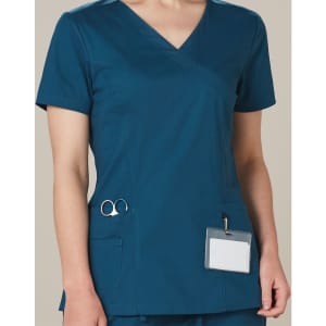 A solid colour teal scrub top with a V-neck, short sleeves, and pockets, featuring a logo on the pocket.