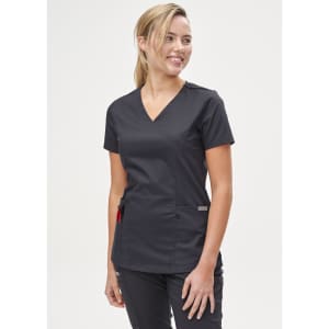 A solid black short-sleeve scrub top worn by a smiling woman, featuring a v-neck and pockets.