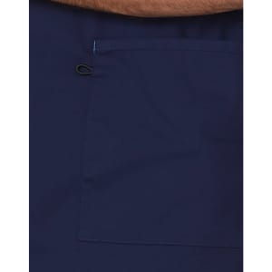 A navy scrub top featuring a large pocket and contrast brown collar. Includes a logo.
