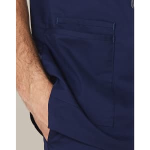Men's scrub top in navy blue with contrast stitching and two front pockets. Features a logo on the fabric.