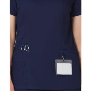 A navy scrub top featuring contrast colour detailing, with pockets for tools and a name badge holder.