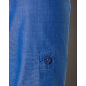 A close-up of a blue women's shirt featuring a button and a rolled-up sleeve. The fabric has a subtle texture.