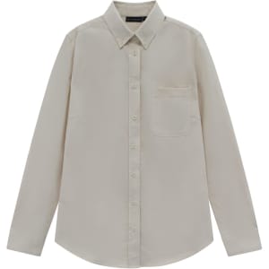 A beige long-sleeve shirt with a collar and a chest pocket, featuring a logo on the tag.
