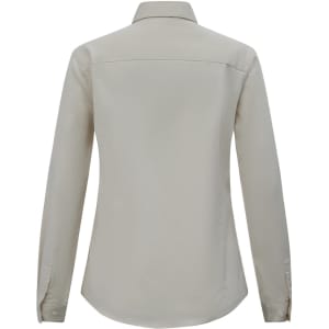 A beige long-sleeve shirt with a collar and button cuffs, featuring a logo on the back.