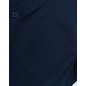 A navy blue long-sleeve shirt with a buttoned collar and a pocket on the front. Features a logo detail.
