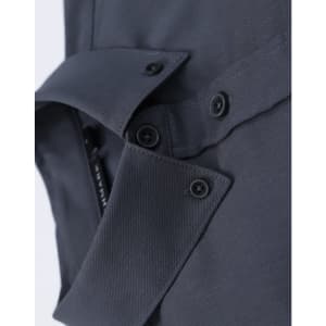 A close-up of a grey cotton blend long-sleeve shirt featuring button details and a collar.