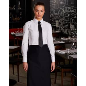 A long-sleeve white cotton/poly stretch shirt with a black tie, worn in a stylish dining setting.