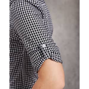 A black and white gingham check roll-up long-sleeve shirt featuring button details on the sleeves and a logo.