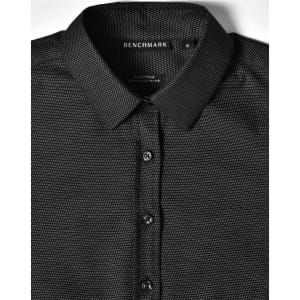 A black pin dot stretch long sleeve button-up shirt with a collar and branded tag.