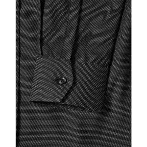 A close-up of a black pin dot stretch long sleeve shirt with a buttoned cuff and subtle pattern details.