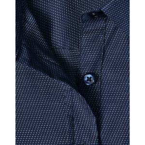 A navy blue ladies' button-up shirt with a pin dot pattern and a blue button. Features a classic collar design.