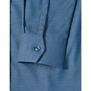 A close-up of a blue pin dot stretch long-sleeve shirt featuring a buttoned cuff and a patterned fabric.