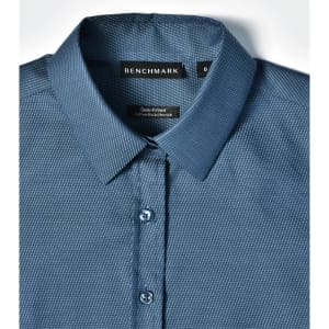 A blue pin dot stretch button-up shirt with a semi-fitted design and collar, featuring a logo tag.