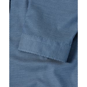 A blue pin dot stretch shirt featuring a 3/4 sleeve and folded cuff detail. Includes a logo.
